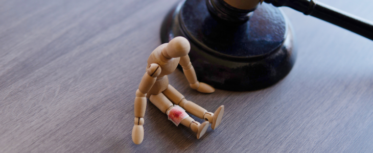 Figurine with an injury to the knee to represent a slip and fall accident injury