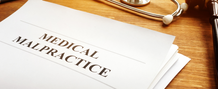 Medical malpractice written on a sheet of paper