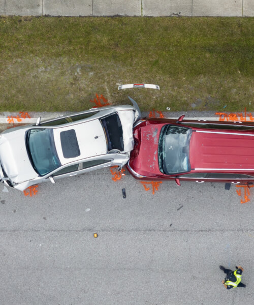 Car crash with two vehicles collided at traffic accident site on American street.